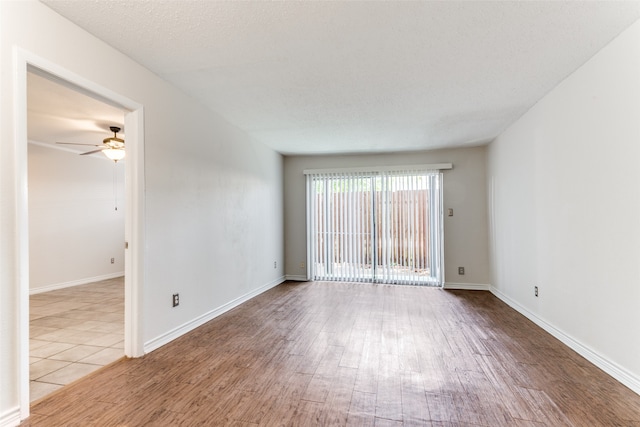 spare room featuring a textured ceiling, hardwood / wood-style floors, and ceiling fan