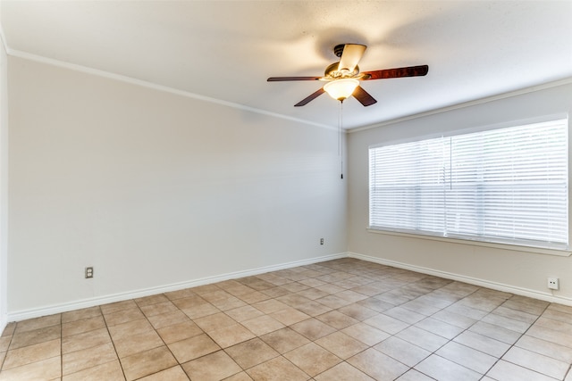 empty room with ceiling fan, crown molding, and light tile patterned floors