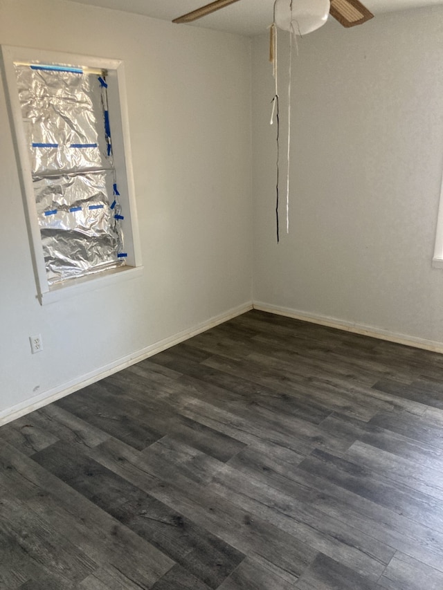 unfurnished room with ceiling fan and dark hardwood / wood-style flooring