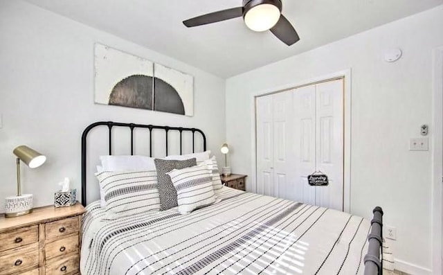 bedroom with ceiling fan, baseboards, and a closet