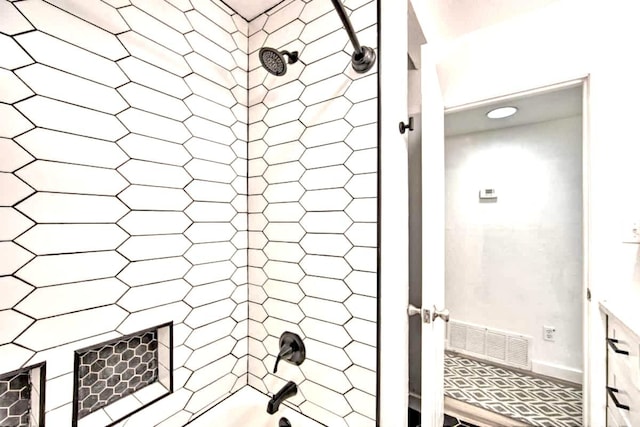 bathroom featuring visible vents and bathing tub / shower combination