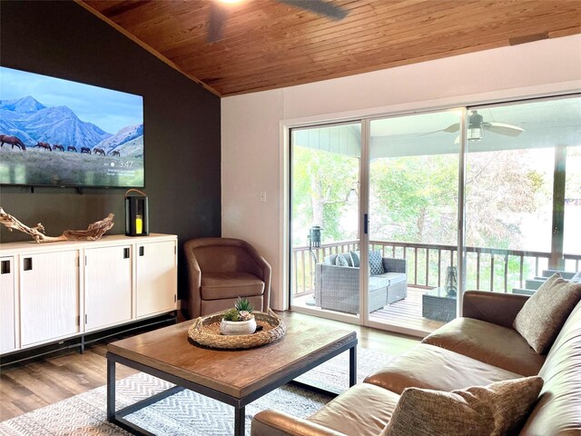 living room featuring light wood-type flooring, lofted ceiling, ceiling fan, and wooden ceiling