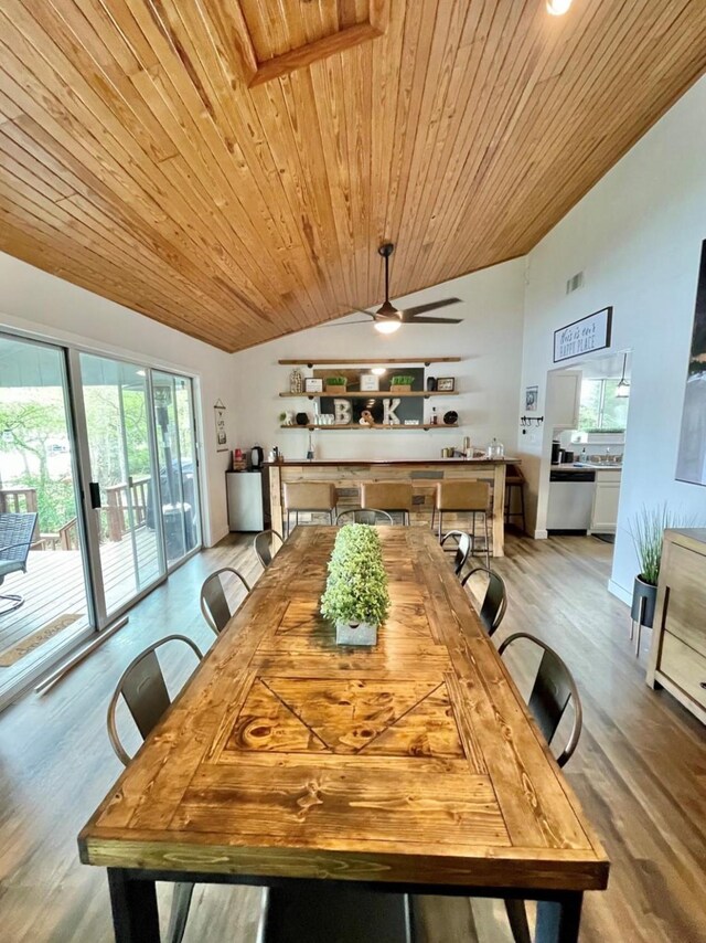 dining area featuring wood ceiling, vaulted ceiling, and light hardwood / wood-style floors