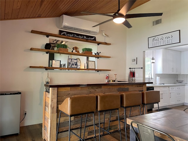 bar with vaulted ceiling, white cabinets, wooden ceiling, ceiling fan, and dark hardwood / wood-style floors