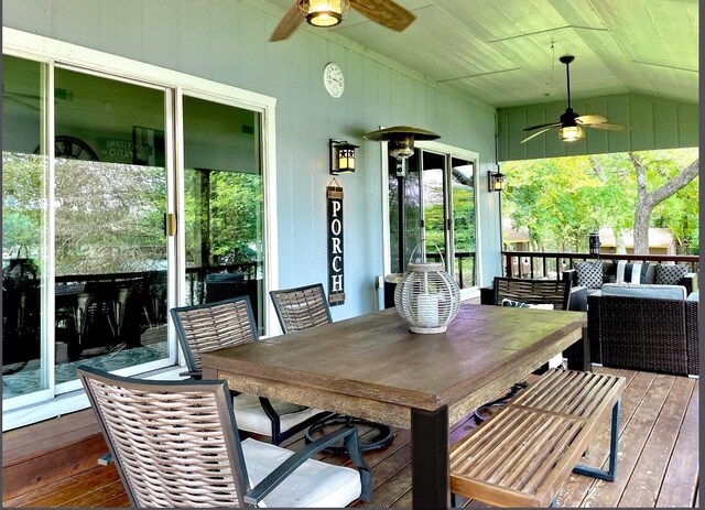 sunroom / solarium with ceiling fan and vaulted ceiling