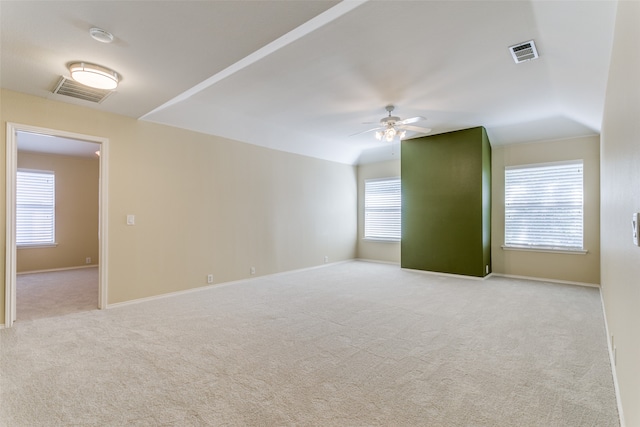 spare room featuring light colored carpet and ceiling fan