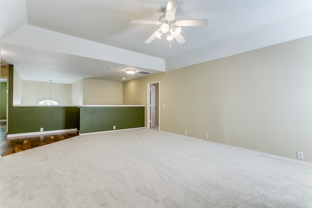 spare room featuring carpet flooring and ceiling fan with notable chandelier