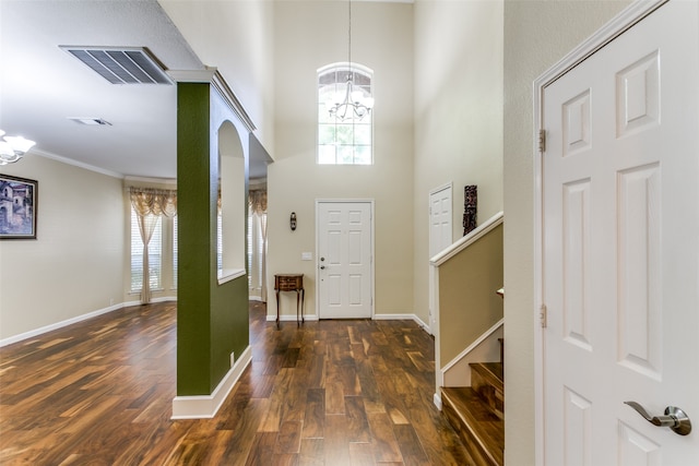 entrance foyer with crown molding, dark hardwood / wood-style flooring, and a healthy amount of sunlight