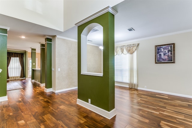 unfurnished room featuring dark wood-type flooring and ornamental molding