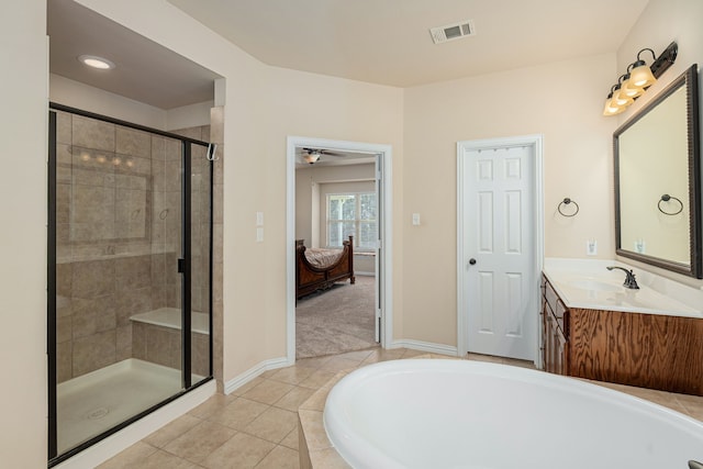 bathroom with tile patterned flooring, ceiling fan, plus walk in shower, and vanity