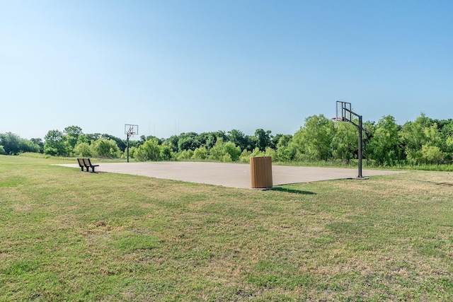 view of basketball court featuring a yard