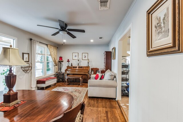 living room with ceiling fan, hardwood / wood-style floors, and ornamental molding