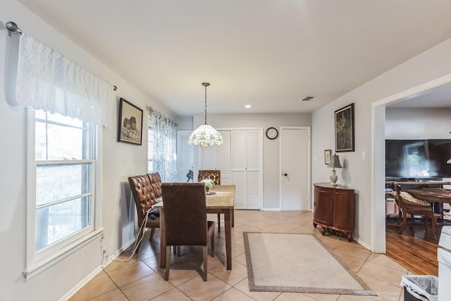 tiled dining area featuring a wealth of natural light