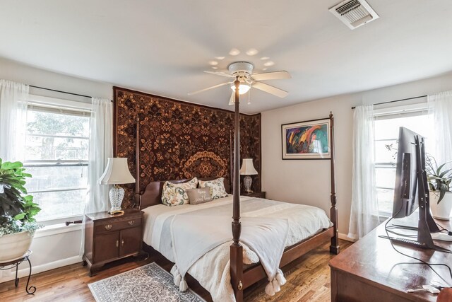 bedroom with ceiling fan and light hardwood / wood-style floors