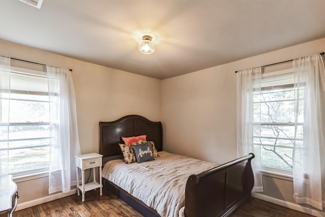 bedroom with dark wood-type flooring