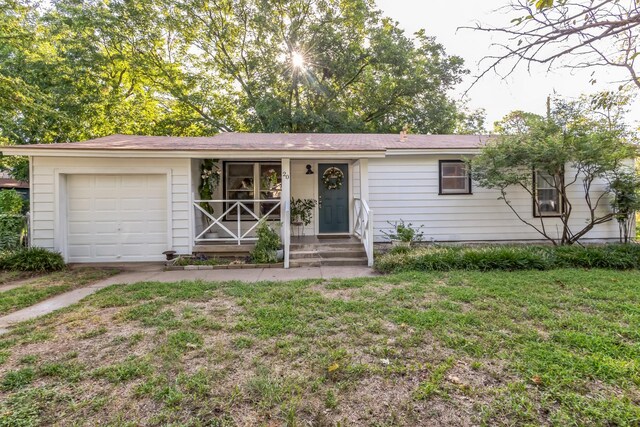 ranch-style house with a front yard and a garage