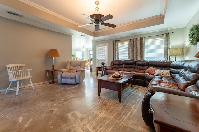 living room with concrete flooring, a tray ceiling, ceiling fan, and crown molding