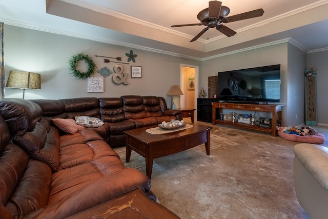 living room with a raised ceiling, crown molding, and ceiling fan