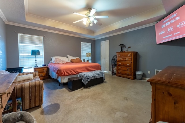 bedroom with a tray ceiling, ceiling fan, light colored carpet, and ornamental molding