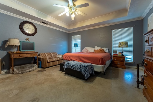 bedroom featuring ceiling fan, ornamental molding, and a tray ceiling