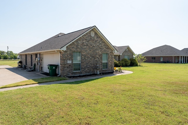 view of home's exterior featuring a lawn and a garage