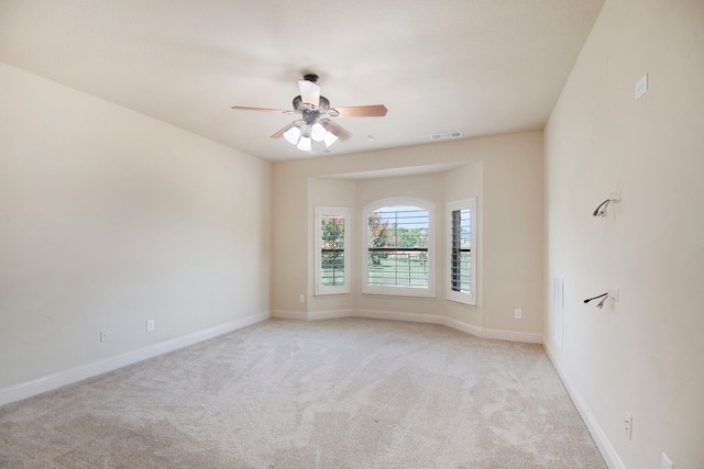 unfurnished room with light carpet and ceiling fan