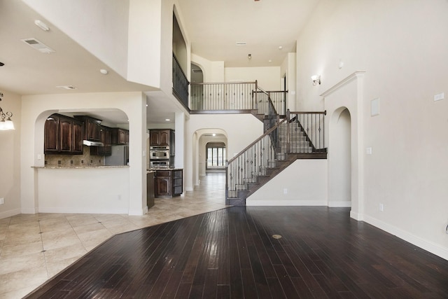 entrance foyer featuring light hardwood / wood-style flooring and a high ceiling