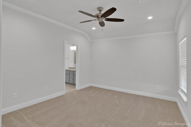 empty room featuring ceiling fan, crown molding, light carpet, and lofted ceiling