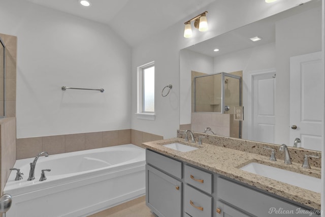 bathroom with vaulted ceiling, double sink vanity, and plus walk in shower