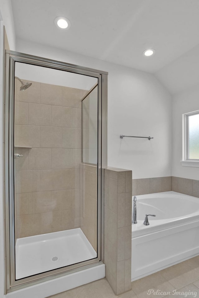 bathroom featuring tile patterned flooring, lofted ceiling, and independent shower and bath