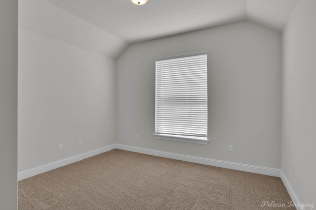 empty room with lofted ceiling and light colored carpet