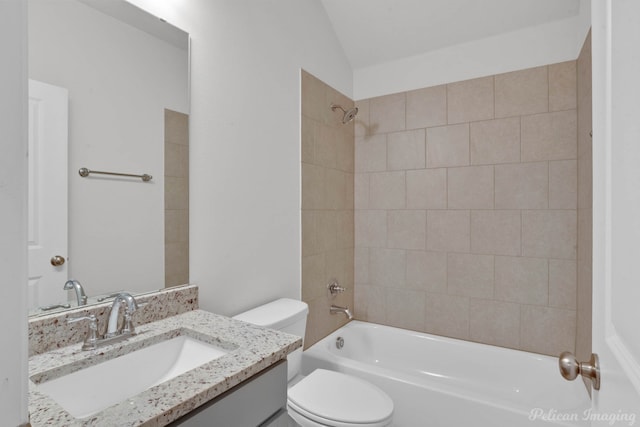 full bathroom with toilet, vanity, vaulted ceiling, and tiled shower / bath