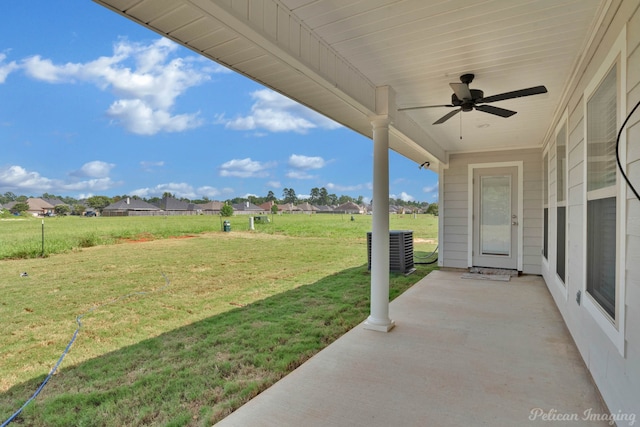 view of yard with ceiling fan, a patio, and central AC