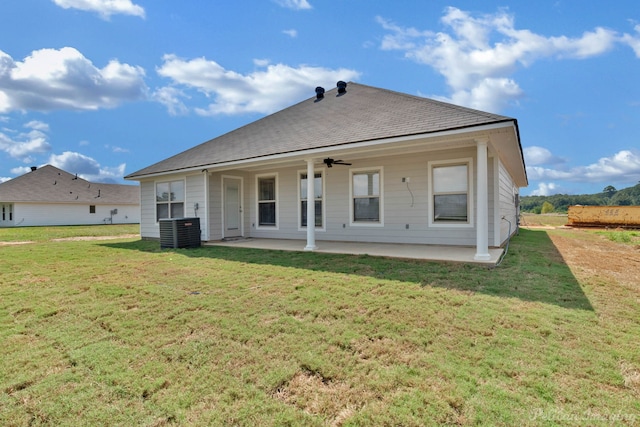 rear view of house featuring ceiling fan, cooling unit, a patio area, and a lawn