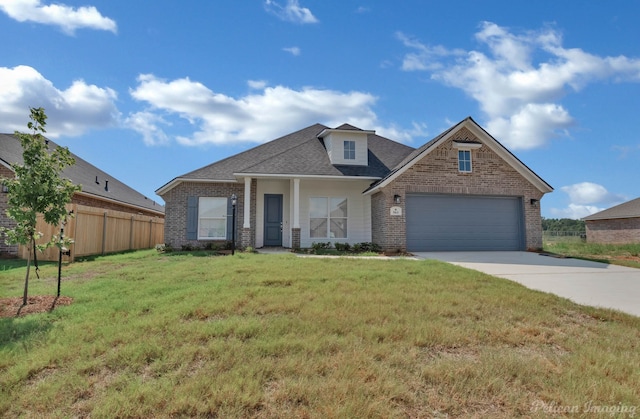 view of front of property with a front lawn and a garage