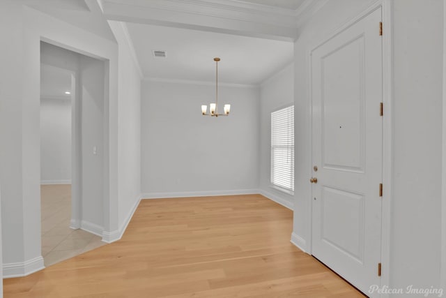 interior space featuring light hardwood / wood-style flooring, an inviting chandelier, and crown molding