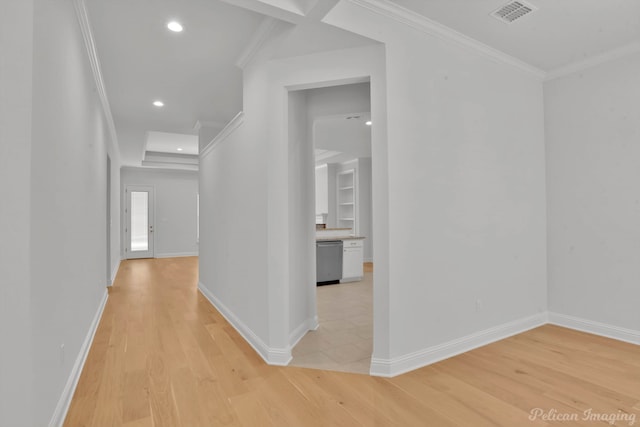 hallway with light tile patterned flooring and ornamental molding