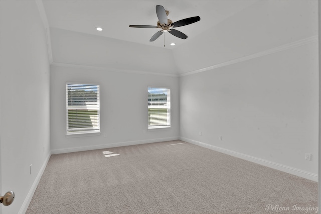 carpeted spare room featuring ceiling fan, lofted ceiling, and crown molding