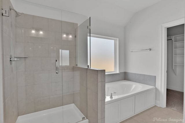 bathroom featuring tile patterned floors, lofted ceiling, and separate shower and tub