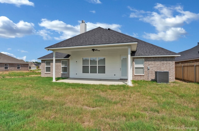 back of property with ceiling fan, central AC unit, a patio area, and a yard