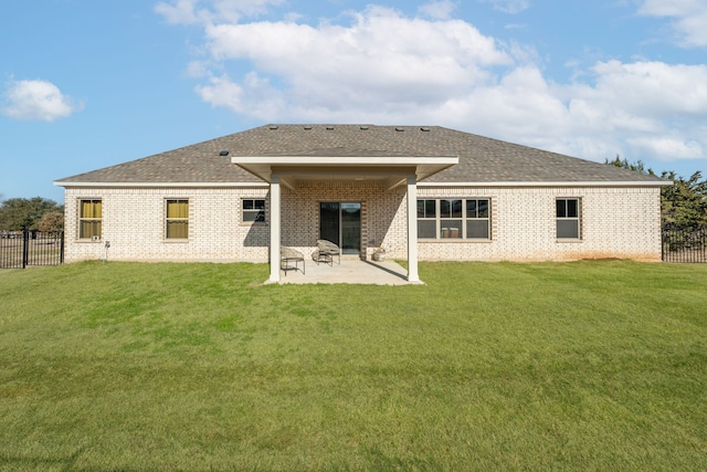 rear view of property with a lawn and a patio area