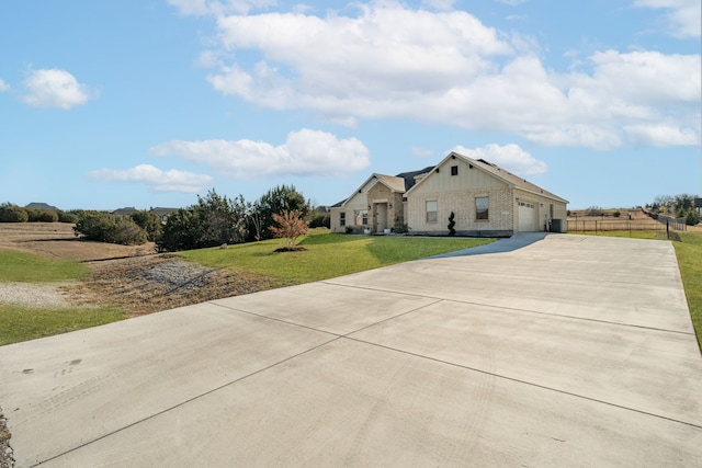 view of front of home with a garage and a front lawn