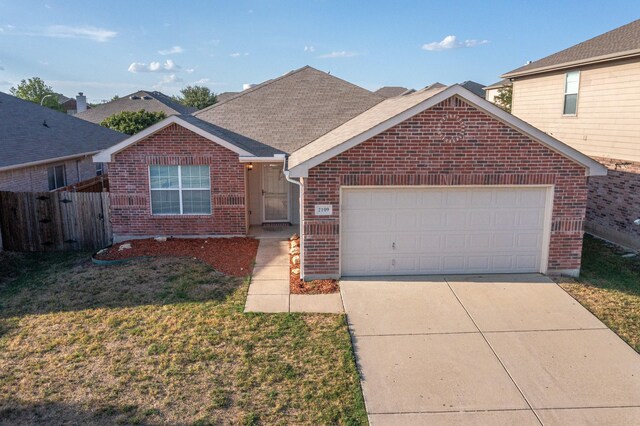 view of front of home with a front yard and a garage