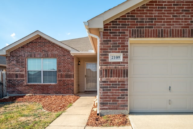 view of exterior entry with a garage