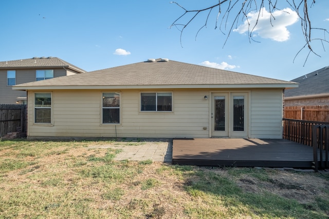 back of house featuring a wooden deck and a yard