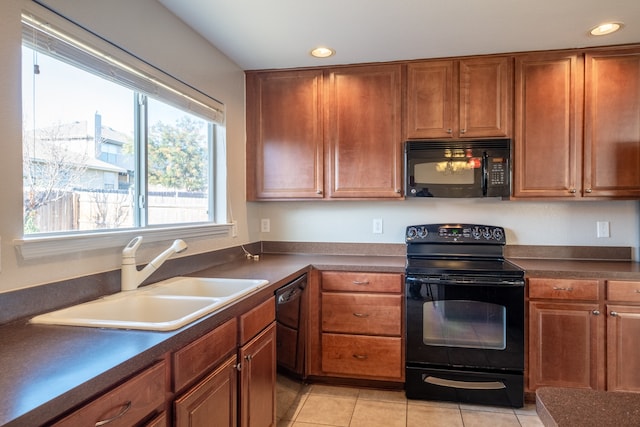 kitchen with black appliances, sink, a healthy amount of sunlight, and light tile patterned floors