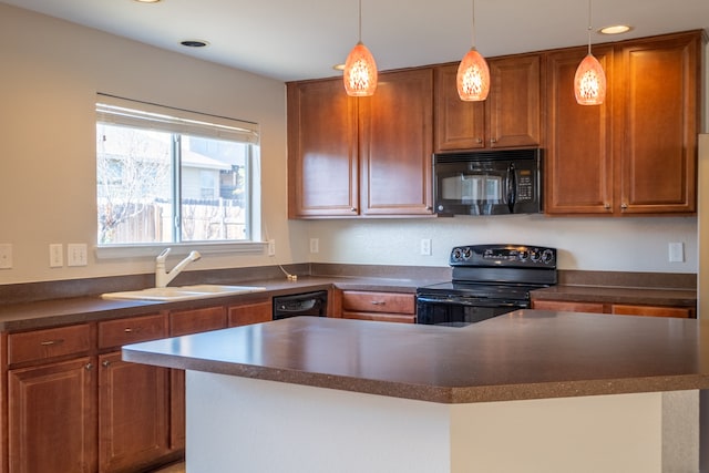 kitchen featuring black appliances, sink, and hanging light fixtures