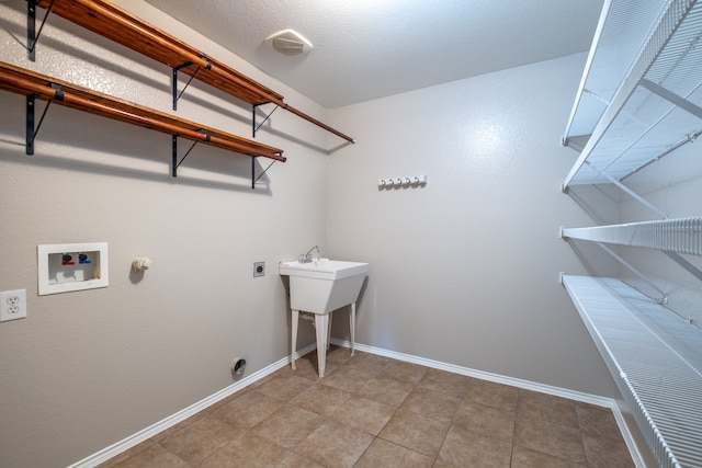 laundry room featuring gas dryer hookup, washer hookup, electric dryer hookup, and tile patterned flooring