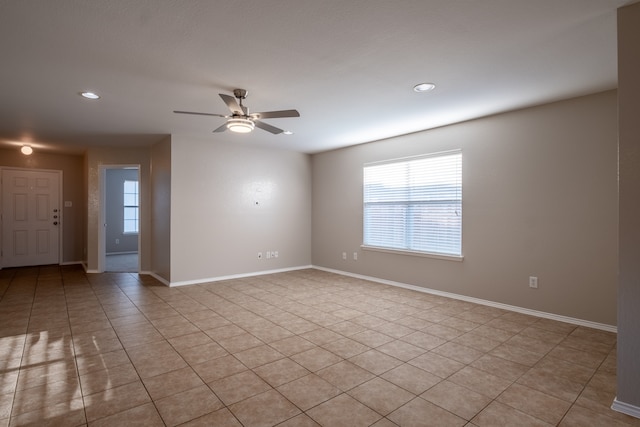 empty room with light tile patterned floors and ceiling fan