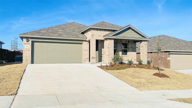 view of front of property featuring central AC and a garage